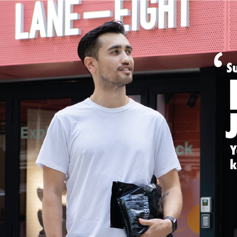 James Shorrock holding invisible bag in front of the LANE EIGHT store